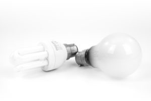 A photo of an energy efficient LED and a bulb kept together on a surface
