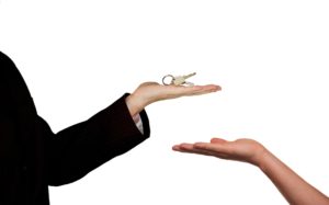 A agent or a landlord handing over the keys to the tenant