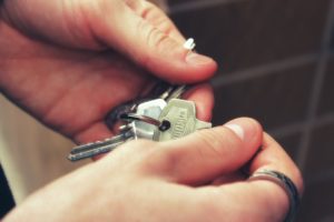 A photo of a person's hand holding bunch of keys